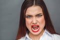 Freestyle. Woman standing on grey shouting angry close-up