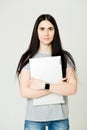 Young woman standing and holding laptop. Happy young girl using her laptop, isolated on white