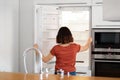 Young Woman Standing In Kitchen And Looking Inside Of Empty Fridge Royalty Free Stock Photo