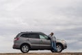 Young woman standing leaning on the car Royalty Free Stock Photo