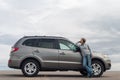 Young woman standing leaning on the car Royalty Free Stock Photo