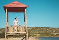 Young woman standing on lifeguard post Royalty Free Stock Photo