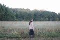 Young woman standing in a misty field in the morning. Autumn morning and sunrise on a misty field. Royalty Free Stock Photo