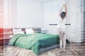 Woman in pajamas in white bedroom corner Royalty Free Stock Photo