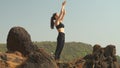 young woman is standing in the Mountain Pose Tadasana Urdhva Hastasana