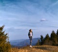 Woman hiker standing on mountain ridge at sunset Royalty Free Stock Photo