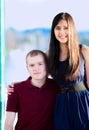 Young woman standing next to seated young man by a lake Royalty Free Stock Photo