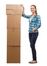 Young woman standing next to tower of boxes