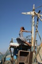 Young woman standing on an old boat looking up