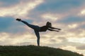 Young Woman Standing On One Leg And Exercising On the Grass Morning Workout, Beautiful Sunrise Royalty Free Stock Photo