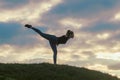 Young Woman Standing On One Leg And Exercising On the Grass Morning Workout, Beautiful Sunrise Royalty Free Stock Photo