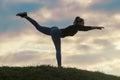 Young Woman Standing On One Leg And Exercising On the Grass Morning Workout, Beautiful Sunrise Royalty Free Stock Photo