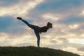 Young Woman Standing On One Leg And Exercising On the Grass Morning Workout, Beautiful Sunrise Royalty Free Stock Photo