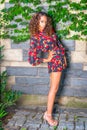 Young woman standing outdoors by wall in New York City, looking forward Royalty Free Stock Photo