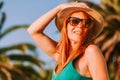 Young woman standing by the palm trees Royalty Free Stock Photo