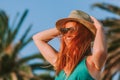 Young woman standing by the palm trees Royalty Free Stock Photo