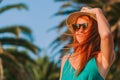 Young woman standing by the palm trees Royalty Free Stock Photo