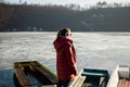 Young woman standing on the pier of a frozen lake Royalty Free Stock Photo