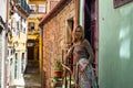 Young woman standing on the porch in the courtyard of the old town, Porto Royalty Free Stock Photo