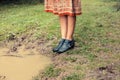 Young woman standing by a puddle in the forest Royalty Free Stock Photo