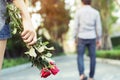 Young woman standing with a Red Rose on Hand Sadness Love in Ending