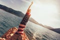 Young woman standing on the reef wrapped in American flag Royalty Free Stock Photo