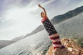 Young woman standing on the reef wrapped in American flag Royalty Free Stock Photo