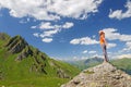 Young woman standing on a rock