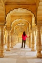 Young woman standing in Sattais Katcheri Hall, Amber Fort, Jaipur, India