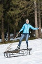 Young woman standing on a sledge Royalty Free Stock Photo