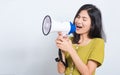 Young woman standing smile holding and shouting into megaphone Royalty Free Stock Photo