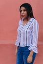 Young woman standing staring blankly with a serious expression Royalty Free Stock Photo