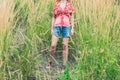 Young woman standing in tall grass Royalty Free Stock Photo