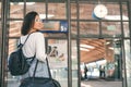 Young woman standing in the trainstation in front of timetables Royalty Free Stock Photo