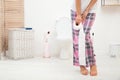 Young woman standing with urine urgency and toilet paper Royalty Free Stock Photo