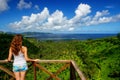 Young woman standing at the viewpoint in Bouma National Heritage Park on Taveuni Island, Fiji