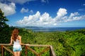 Young woman standing at the viewpoint in Bouma National Heritage