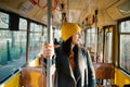 Young woman standing in a wagon of a driving tramway. Transportation, travel and lifestyle concept Royalty Free Stock Photo