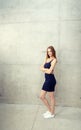 Young woman standing - wall Royalty Free Stock Photo