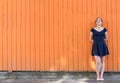 Young woman standing on a wall thinking Royalty Free Stock Photo