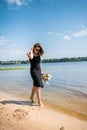 young woman stands barefoot in river Royalty Free Stock Photo