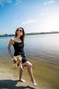 young woman stands barefoot in river Royalty Free Stock Photo