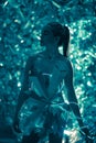 Young woman stands in cosmic image of extraterrestrial goddess with shiny body art and neon lights Royalty Free Stock Photo