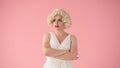 A young woman stands offended. Portrait of a woman in the image of Marilyn Monroe, wearing a white dress and white wig Royalty Free Stock Photo