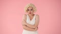 A young woman stands offended. Portrait of a woman in the image of Marilyn Monroe, wearing a white dress and white wig Royalty Free Stock Photo