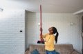 Young woman stares at the ceiling and yells because a neighbor upstairs is having a party with loud music or renovating an