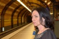 Young woman staring anxiously down the tracks Royalty Free Stock Photo