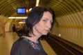 Young woman staring anxiously down the tracks Royalty Free Stock Photo