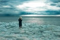Young woman stay on the ice floe, Thunder Sky and sea