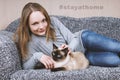 Young woman staying at home with cat